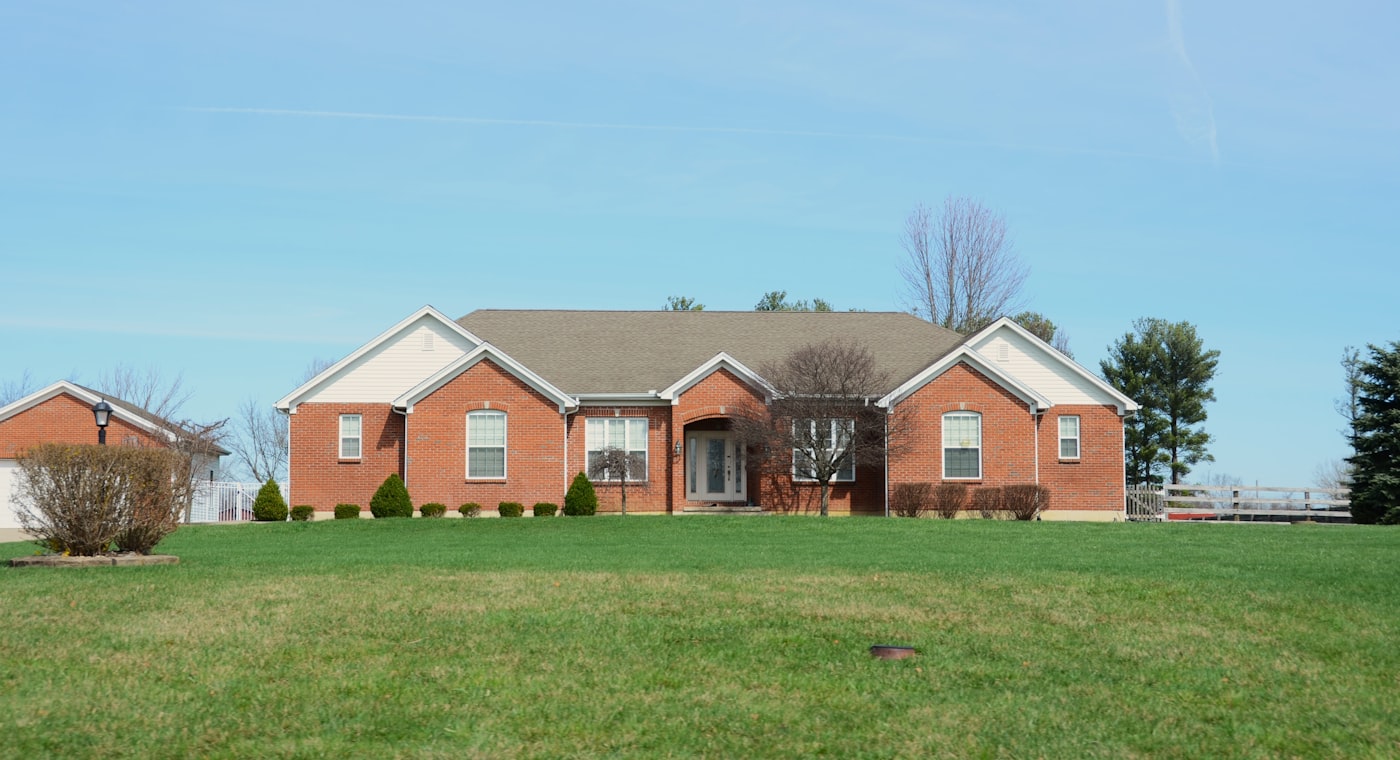 A single-storey brick house with a front garden